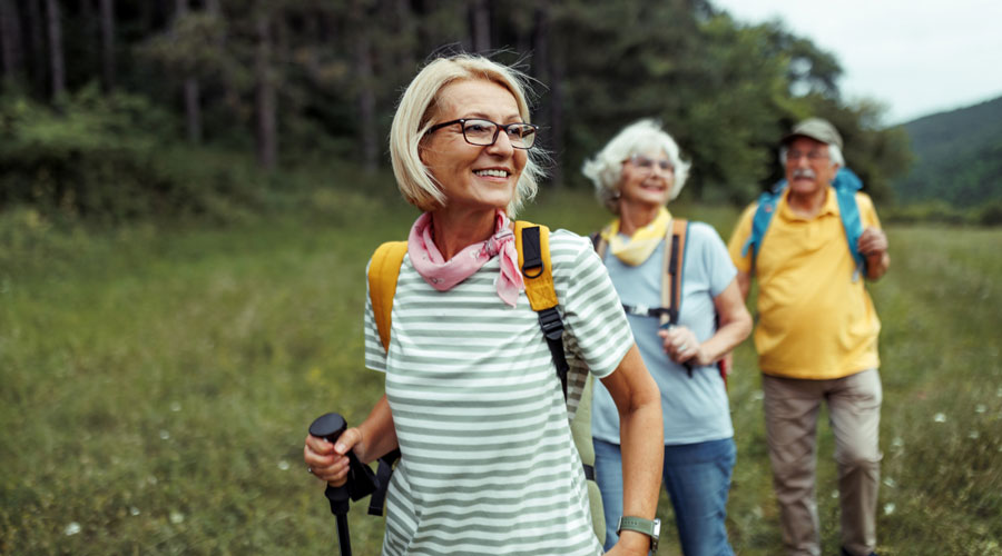 three seniors hiking