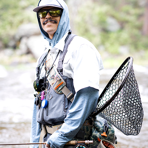 man decked out in fishing gear