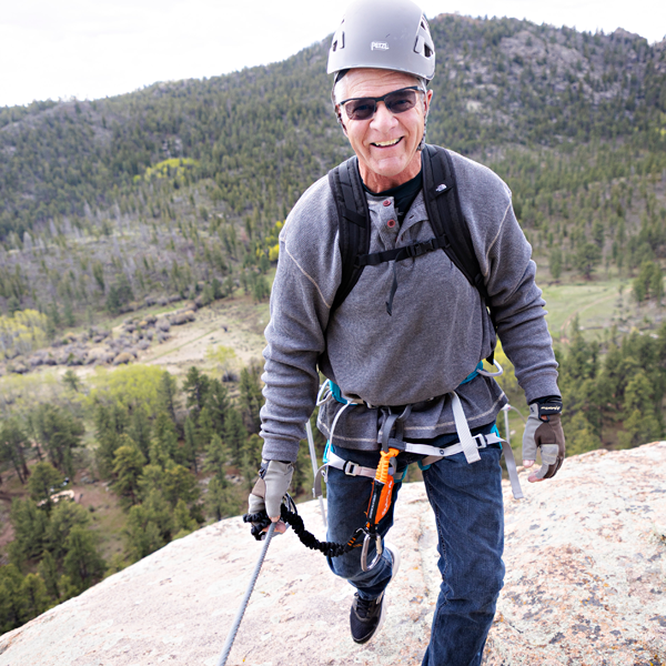 man with rock climbing equipment on