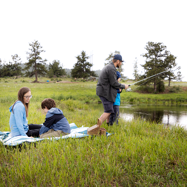 family enjoying a day fishing and relaxing outside