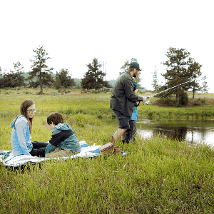 Family enjoying a day fishing and relaxing outside near Shoshana Ranch