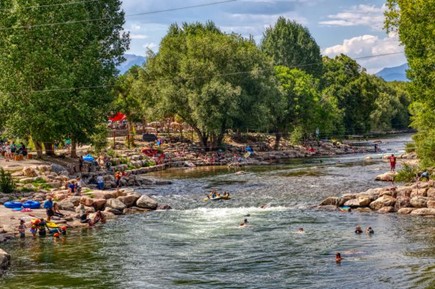 People enjoying river activities in Colorado mountain landscape