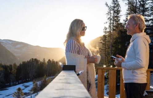Rustic multi-story cabin in Colorado forest with pine trees