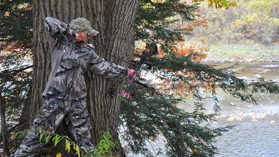 A person wearing camouflage clothing and doing bowhunting near Shoshana Ranch